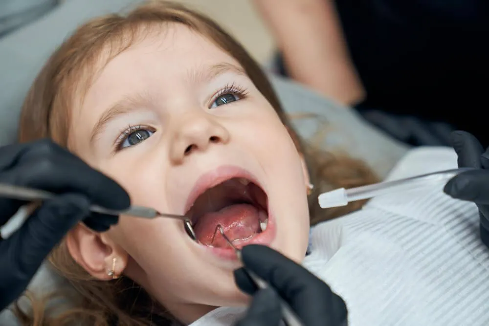 a kid getting her dental examination